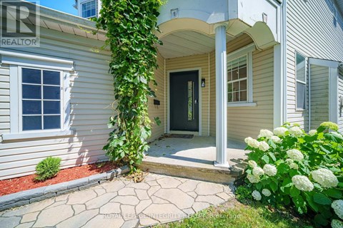 A house with a black door and a window is shown.