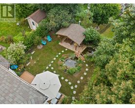 A backyard with a patio and a gazebo.