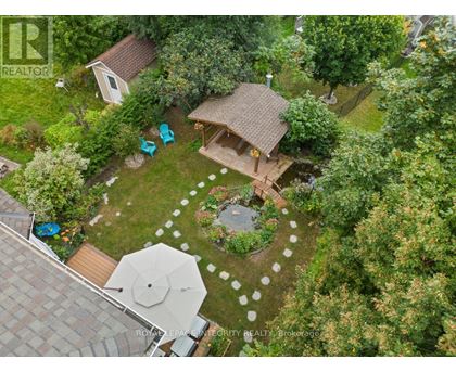 A backyard with a patio and a gazebo.