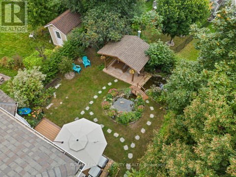 A backyard with a patio and a gazebo.