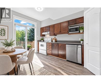 A kitchen with brown cabinets and a white fridge.