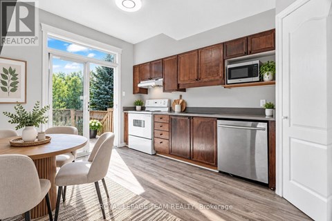 A kitchen with brown cabinets and a white fridge.