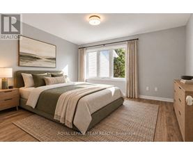 A bedroom with a large bed and a painting on the wall.