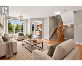 A living room with a couch, coffee table, and staircase.