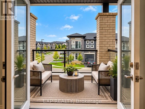 A patio with a table and chairs is shown through a glass door.