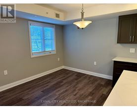 A room with a window and wooden flooring.
