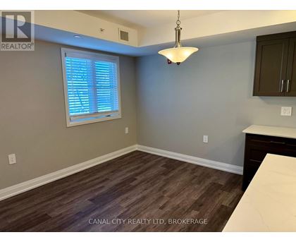 A room with a window and wooden flooring.