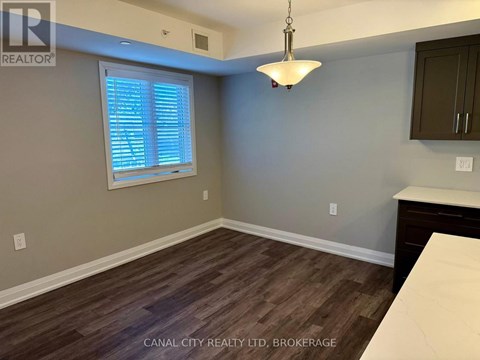 A room with a window and wooden flooring.
