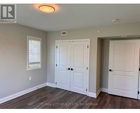 A room with a white door and a window with blinds.