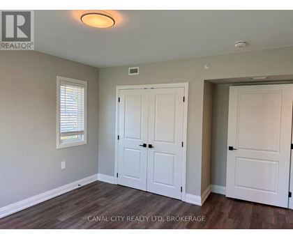 A room with a white door and a window with blinds.