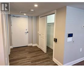 A room with a white door and a glass door leading to a balcony.