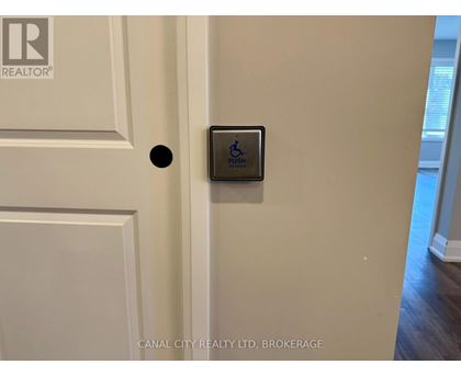 A brokerage sign is on the door.