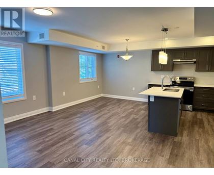A kitchen area with a counter and cabinets.