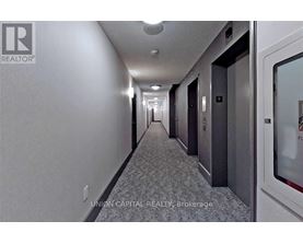 A long hallway with doors on the right side.