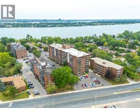 A bird's eye view of a residential area with apartment buildings and cars parked in front.