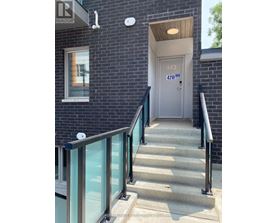 A set of stairs leading to a door with the number 443 on it.