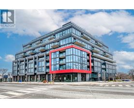 A modern multi-story building with a red accent on the front.