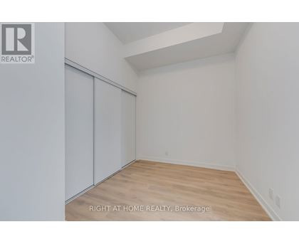 A room with a slanted ceiling and a wood floor.