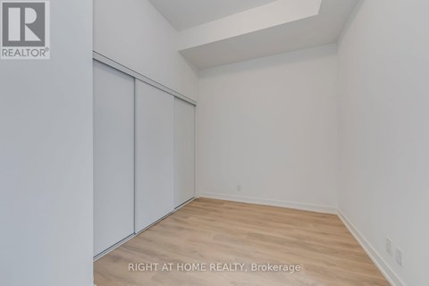 A room with a slanted ceiling and a wood floor.