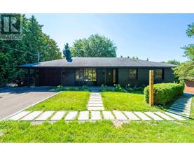 A house with a green lawn in front of it.