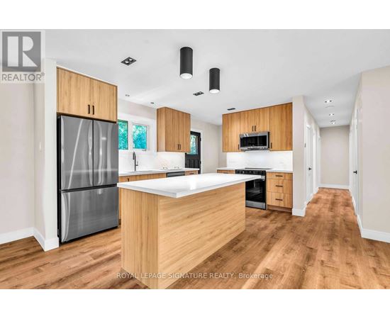 A modern kitchen with wooden cabinets and a central island.