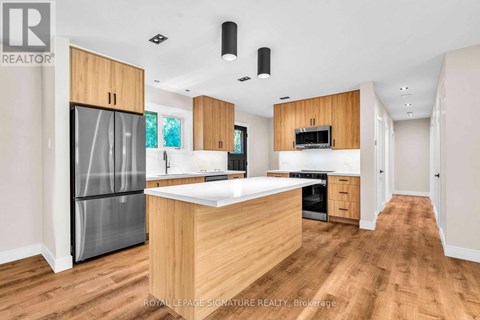 A modern kitchen with wooden cabinets and a central island.