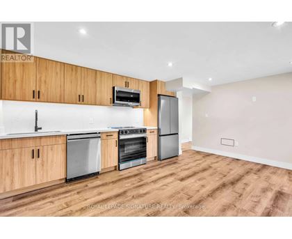A kitchen with wooden cabinets and stainless steel appliances.