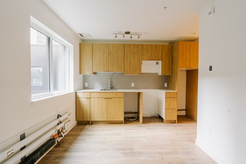 A kitchen with wooden cabinets and a white countertop.