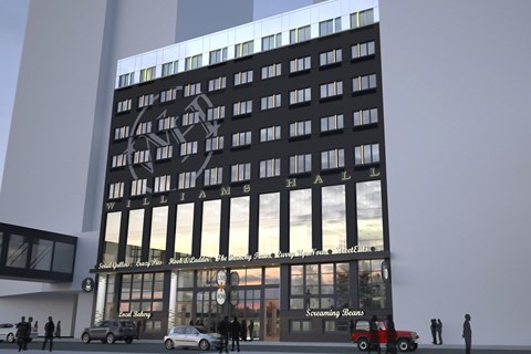 A modern building with a glass facade and a logo on the front.