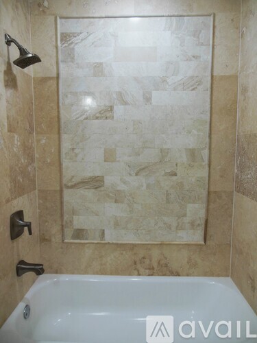 A bathroom with a tiled shower and a bathtub.