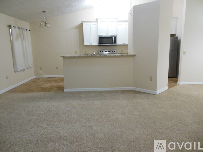 A kitchen area with a microwave, oven, and stove top.
