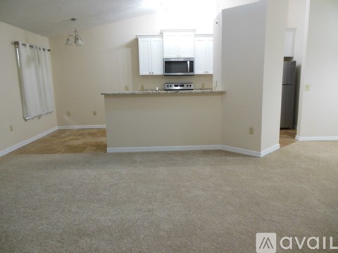 A kitchen area with a microwave, oven, and stove top.