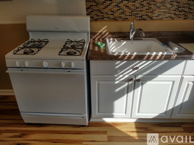 A white stove and sink in a kitchen.