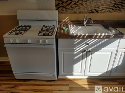A white stove and sink in a kitchen.