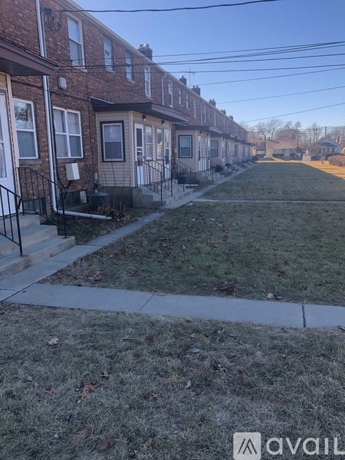 A row of houses with a grassy area in front.