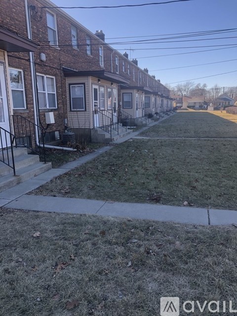 A row of houses with a grassy area in front.