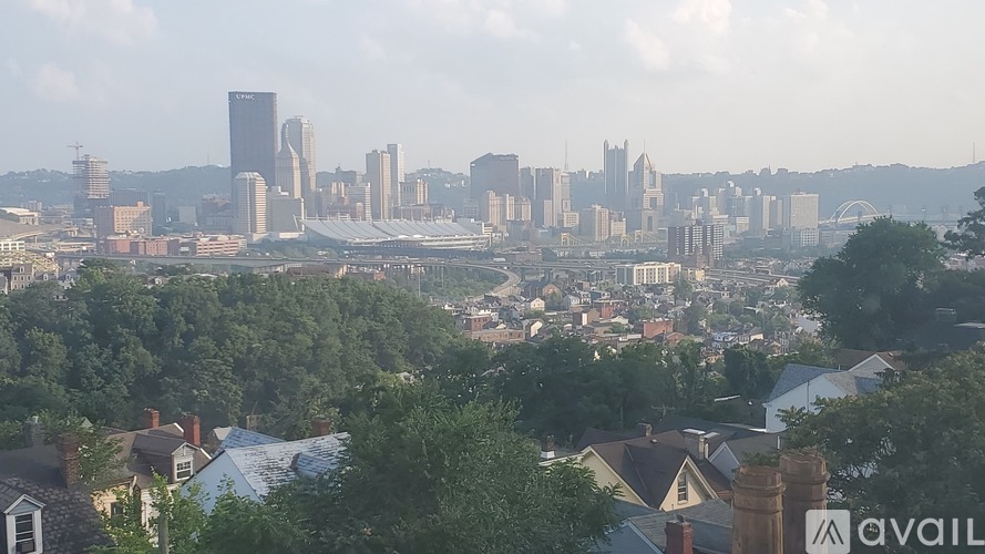 A cityscape with buildings and houses in the foreground.