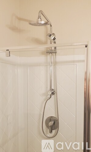 A shower head with a hose attached to it.