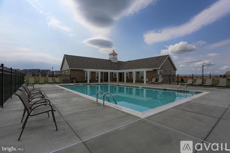 A pool with a building behind it.