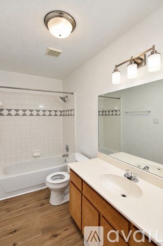 A bathroom with a white toilet, a white sink, and a white bathtub.