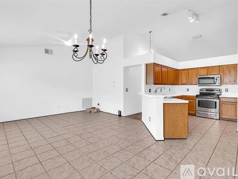 A kitchen with wooden cabinets and a white fridge.