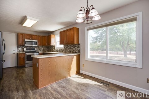A kitchen with wooden cabinets and a large island.