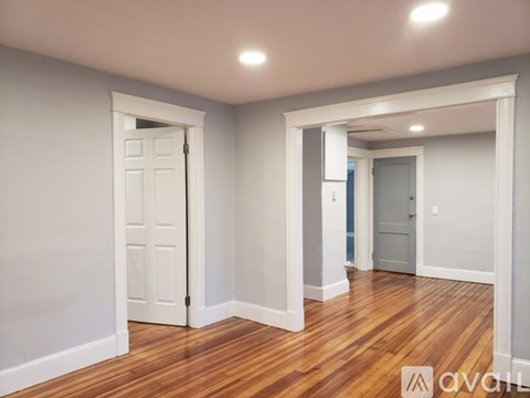 A room with wooden floors and white walls.