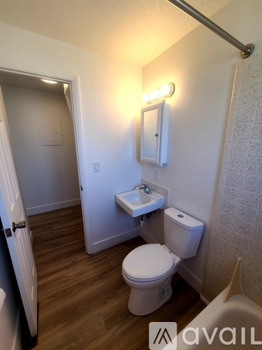 A small white toilet in a small bathroom.
