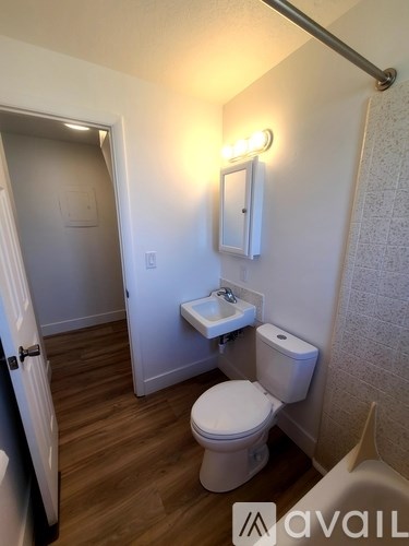 A small white toilet in a small bathroom.