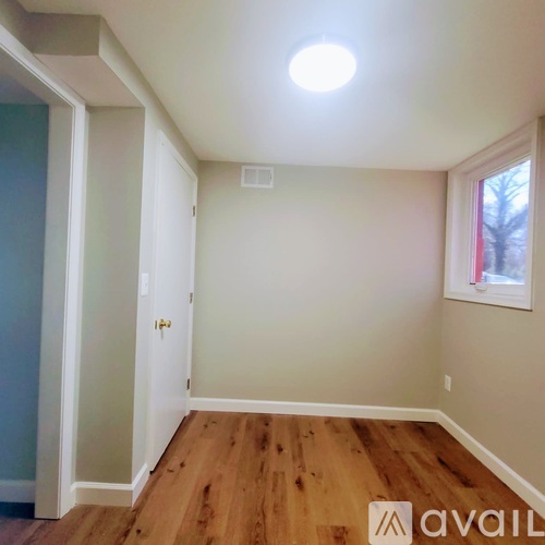 A room with wooden floors and a window.