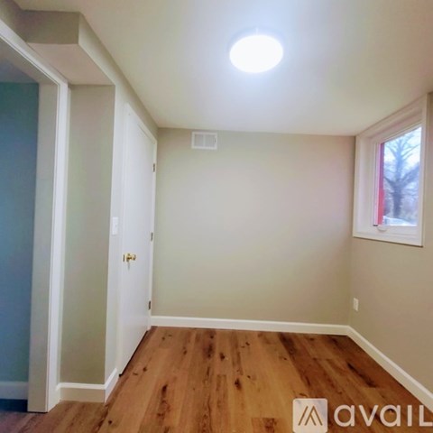 A room with wooden floors and a window.