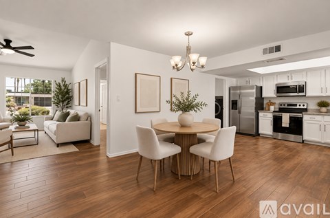 A modern kitchen with a dining table and chairs.