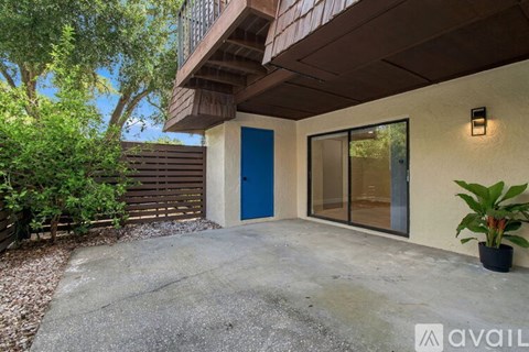 A blue door is on the right side of a building.