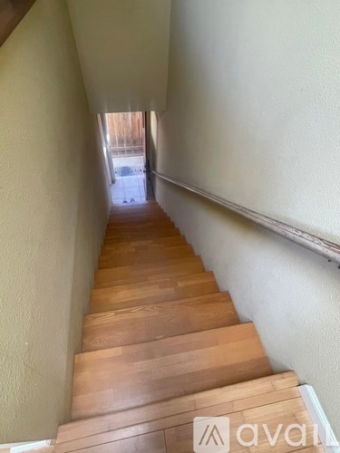 A flight of wooden stairs leads to a doorway.